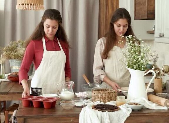Friends cooking together in a cozy kitchen while preparing food