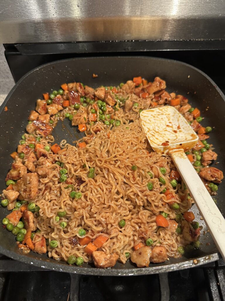 Pork Asian Noodles with pork, ramen noodles, vegetables, and teriyaki sauce