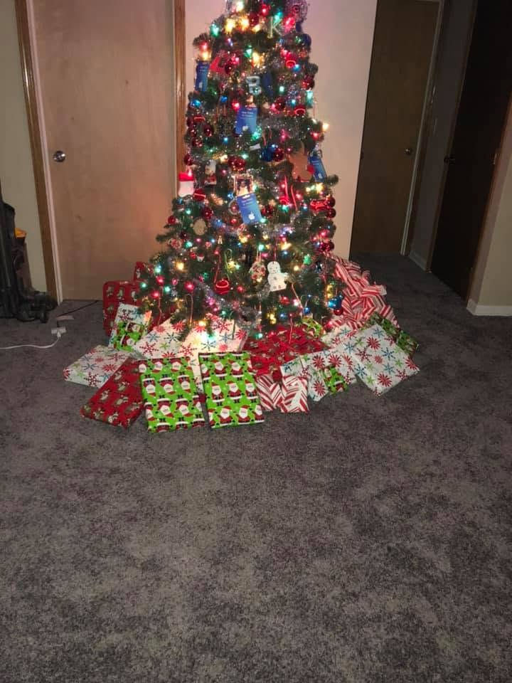 Christmas tree surrounded by wrapped gifts in 2018